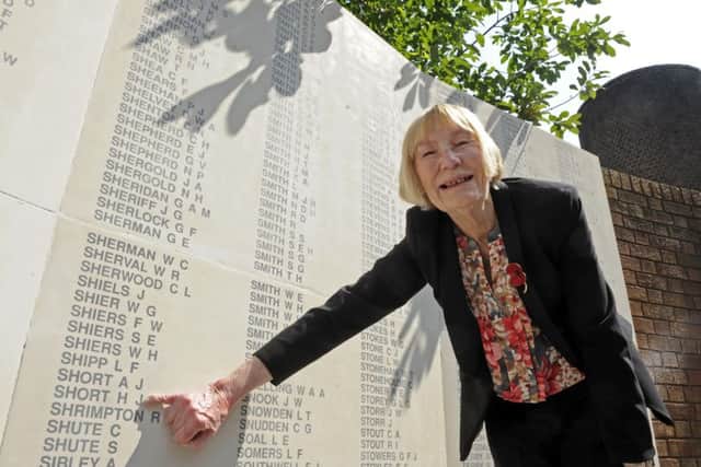 Jean Louth by the nameof her father Harry Short on the Second World War memorial in Guildhall Square
