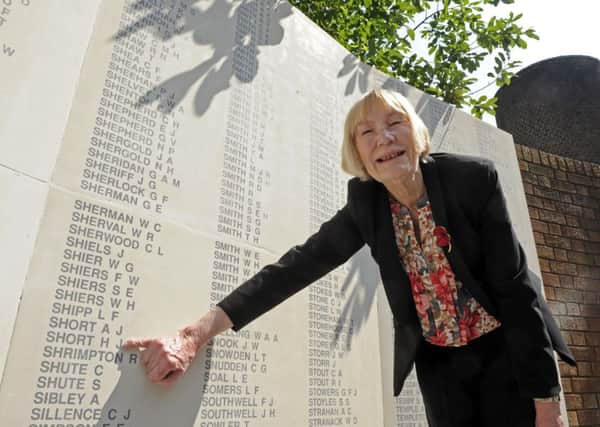 Jean Louth by the nameof her father Harry Short on the Second World War memorial in Guildhall Square