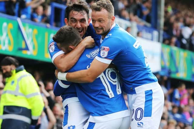 Gary Roberts was at the centre of celebrations as Pompey enjoyed a 2-0 win against Colchester today Picture: Joe Pepler