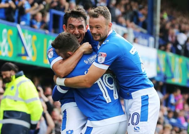 Gary Roberts was at the centre of celebrations as Pompey enjoyed a 2-0 win against Colchester today Picture: Joe Pepler