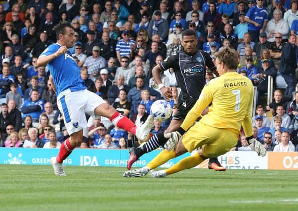Gary Roberts scores Pompey's second goal in their 2-0 victory against Colchester Picture: Joe Pepler