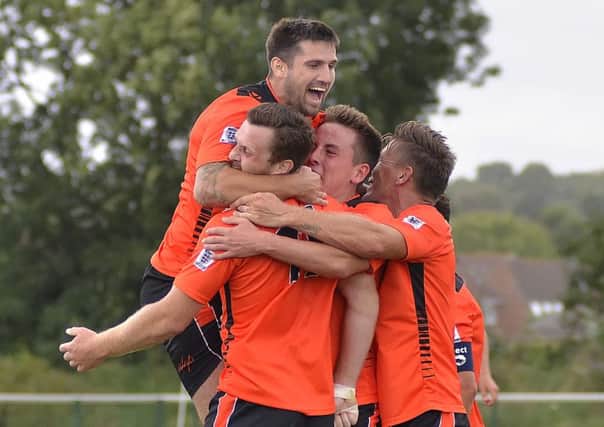 Joe Noakes is mobbed by his Portchester team-mates. Picture: Joe Pepler