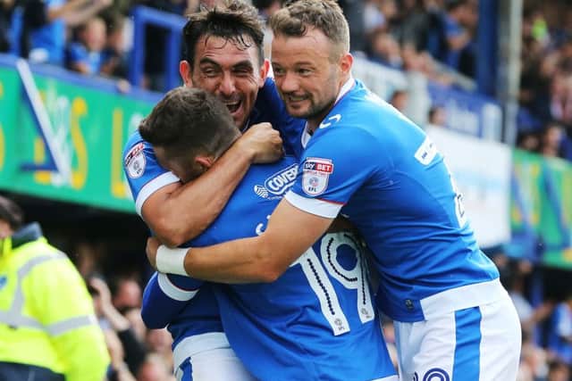 Gary Roberts celebrates with substitutes Conor Chaplin and Noel Hunt. Picture: Joe Pepler