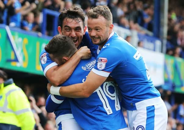 Gary Roberts celebrates with substitutes Conor Chaplin and Noel Hunt. Picture: Joe Pepler