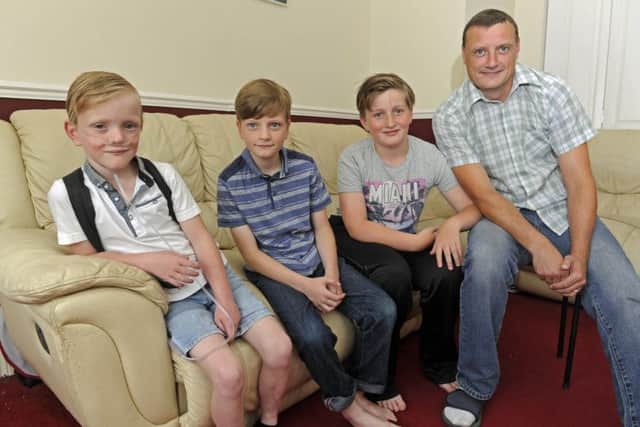 From left, Sam Merrick, eight, with his brothers Liam, 10, and Kiran, 11, and dad Paul 
Picture: Ian Hargreaves