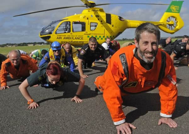 Andy Ellwood leads the emergency services team in the push-up challenge Picture: Ian Hargreaves