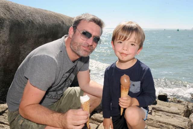 Stuart Johnson (39) from West Meon, enjoying an ice cream with his son Jack Johnson (4) on Southsea seafront.Picture: Sarah Standing (161130-1520)