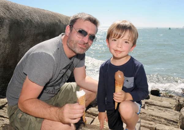 Stuart Johnson (39) from West Meon, enjoying an ice cream with his son Jack Johnson (4) on Southsea seafront.

Picture: Sarah Standing (161130-1520)