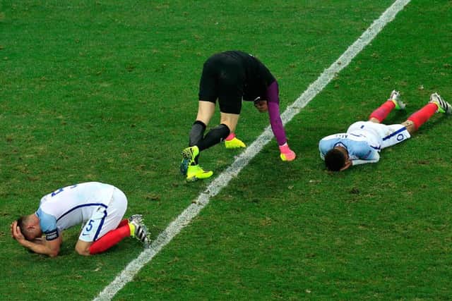 England's goalkeeper Joe Hart, left, defender Gary Cahill, bottom and midfielder Dele Alli show their dejection after the final whistle during the Round of 16 match at Stade de Nice after losing to Iceland