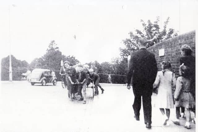 Cubs from the 54 Great Salterns group heave their trekking cart over Copnor Bridge, Copnor, Portsmouth, in the early 1950s.