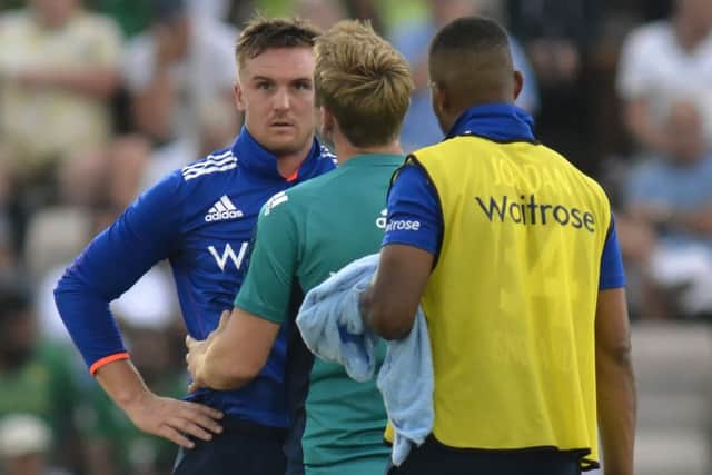Jason Roy is treated on the pitch. Picture: Neil Marshall