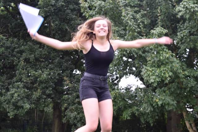 Kayleigh Barton, 16, from Whiteley jumps for joy at Henry Cort Community College in Fareham.
Picture: Loughlan Campbell