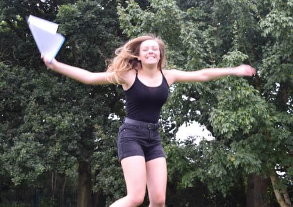 Kayleigh Barton, 16, from Whiteley jumps for joy at Henry Cort Community College in Fareham.

Picture: Loughlan Campbell