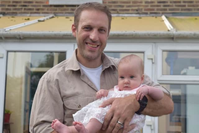 Marathoner Tim Webster, 41 with his seven-month-old daughter Freya at their home in Baffins