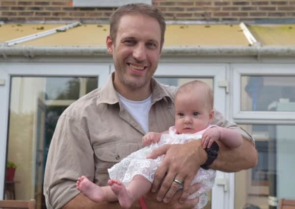 Marathoner Tim Webster, 41 with his seven-month-old daughter Freya at their home in Baffins