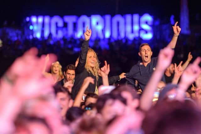 Music fans enjoy Tinie Tempah performing on the Castle Stage. Music fans enjoy rain at dlast year's Victorious Festival, Portsmouth. Picture: Allan Hutchings