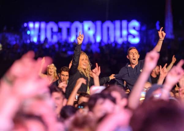Music fans enjoy Tinie Tempah performing on the Castle Stage.   Music fans enjoy rain at dlast year's Victorious Festival, Portsmouth.   Picture: Allan Hutchings