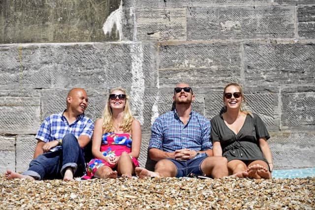 Pictured from left: A group of friends relax in the sun at the Hot Walls in Portsmouth.
Picture: Solent News & Photo Agency