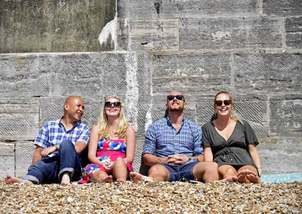 Pictured from left: A group of friends relax in the sun at the Hot Walls in  Portsmouth.
Picture: Solent News & Photo Agency
