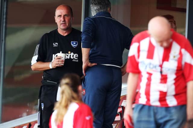 Pompey boss Paul Cook takes his seat in the stands at Exeter on Saturday. Picture: Joe Pepler