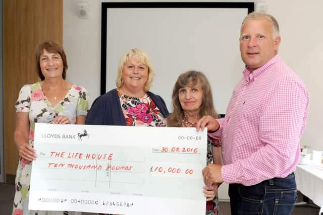Mark Smith presents the Â£10,000 cheque to  Carole Price, Lesley Wenden, and Hilary Frost from The LifeHouse in Southsea Picture: Sarah Standing (161246-5704)