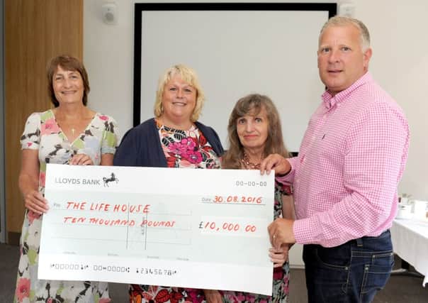 Mark Smith presents the Â£10,000 cheque to  Carole Price, Lesley Wenden, and Hilary Frost from The LifeHouse in Southsea 

Picture: Sarah Standing (161246-5704)