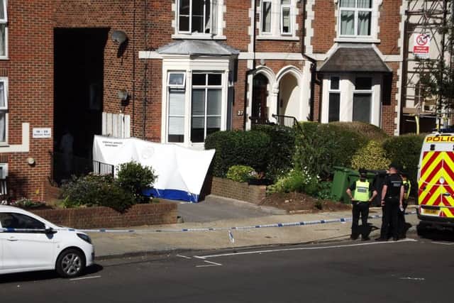 Forensics officers in Outram Road, Southsea, where a man's body was discovered and another held on suspicion of murder