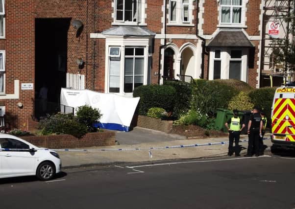 Forensics officers in Outram Road, Southsea, where a man's body was discovered and another held on suspicion of murder