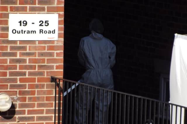 Forensics officers in Outram Road, Southsea, where a man's body was discovered and another held on suspicion of murder