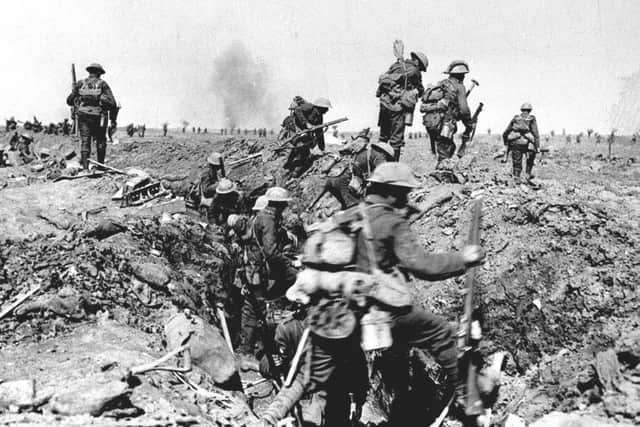 British troops negotiate a trench as they go forward in support of an attack on the village of Morval during the Battle of the Somme