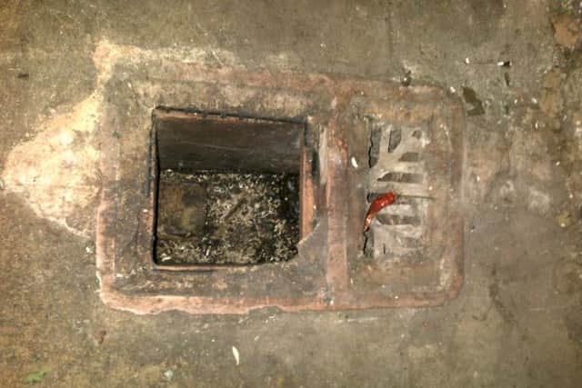 An open drainage channel in the rear large food store next to the walk-in fridge and walk-in freezer.