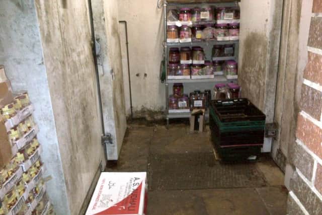 Dirty exteriors of the walk-in fridge and walk-in freezer in the large rear food store.