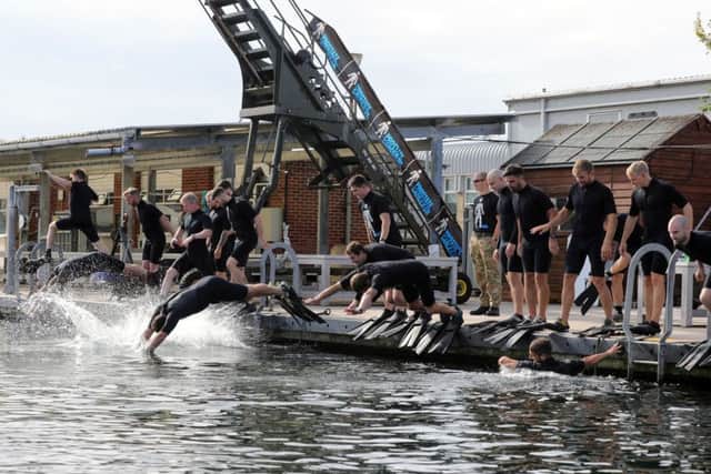 The frogmen diving into Horsea Lake Picture: L(Phot) Sean Gascoigne