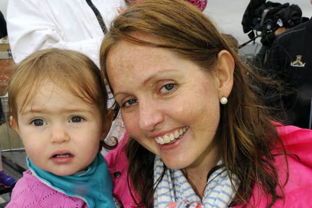Philippa Kadinopoulos  with her daughter Olivia  as they say goodbye to husband and father Weapons Engineering Officer Lieutenant Commander Ben Kadinopoulos  (160902-4672)