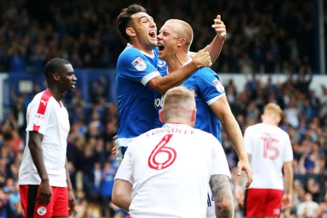 Pompey goalscorers Gary Roberts, left, and Curtis Main celebrate after the latter's opener in today's 3-0 win over Crawley Town Picture: Joe Pepler