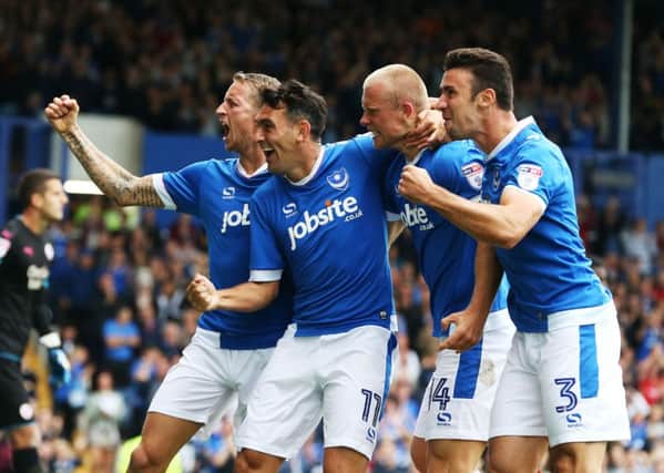 From left: Carl Baker, Gary Roberts, Curtis Main and Enda Stevens celebrate as Pompey run riot in the first-half at Fratton Park  Picture: Joe Pepler