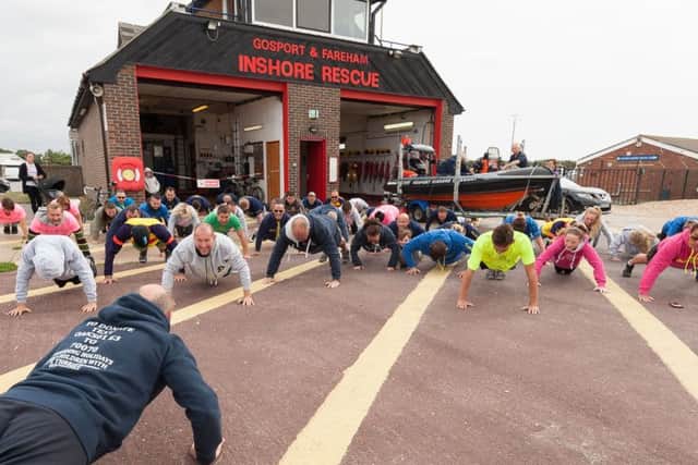 Martyn Webb, a former Chief Petty Officer PTI,  lead the Oakley Waterman Caravan Trust in their 22 push-ups in support of millitary personnel suffering from PTSD.  Picture:: Keith Woodland