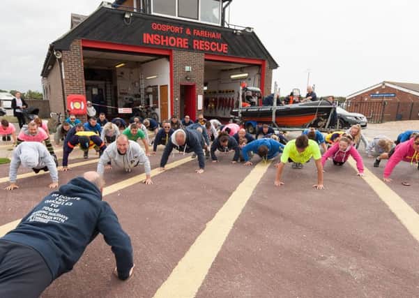 Martyn Webb, a former Chief Petty Officer PTI,  lead the Oakley Waterman Caravan Trust in their 22 push-ups in support of millitary personnel suffering from PTSD.  Picture:: Keith Woodland
