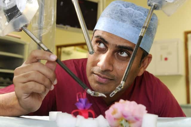 Dr Jim Khan, surgeon at QA hospital, with the Da Vinci robot