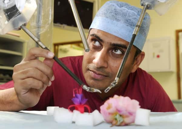 Dr Jim Khan, surgeon at QA hospital, with the Da Vinci robot