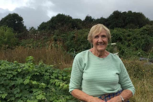 Molly Mills, 82, of Seafield Road, Portchester in her garden overlooking the old allotment site.
Picture: Loughlan Campbell