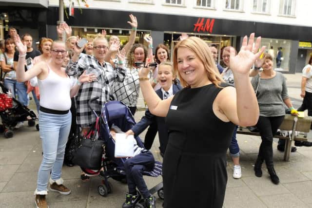 Manager Sarah Tweedale gets a cheer from the crowd waiting to go into her branch of WH. Smith to meet Peter Andre Picture: Malcolm Wells (160906-5397)