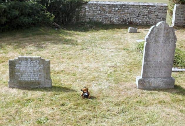 A children's toy marks the spot where Isabella and Andrew Gibson are buried. Picture: Bob Hind