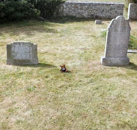 A children's toy marks the spot where Isabella and Andrew Gibson are buried. Picture: Bob Hind