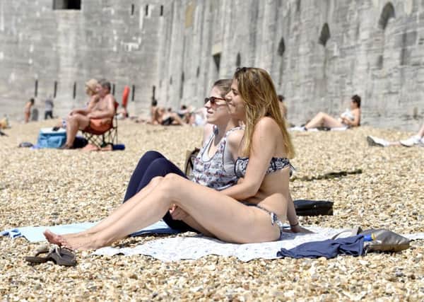 People enjoy the sun and hot weather earlier this year at the Hot Walls in  Portsmouth. 
Picture:  Solent News & Photo Agency