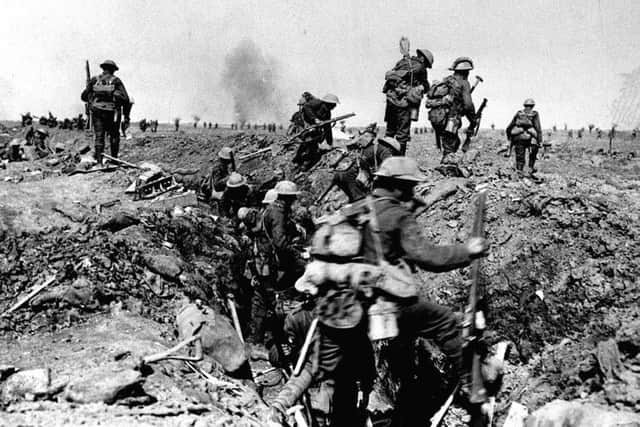 British troops negotiate a trench as they go forward in support of an attack on the village of Morval during the Battle of the Somme