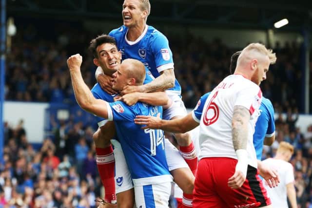 Carl Baker, top, celebrates with goalscorers Gary Roberts and Curtis Main during last Saturdays 3-0 win against Crawley