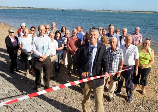 Richard Craven, harbour master and director of Chichester Harbour Conservancy, cuts the ribbon to celebrate the completion of the last stage by the Friends of Nore Barn Woods 

Picture: Sarah Standing (161258-6439)