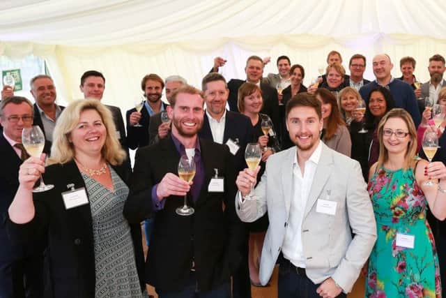 Hybrid Legal's summer drinks party at Hambledon Vineyard with, front from left, Employment Associate Laura Bowyer, Director Matt Schrader, Managing Director Ryan Lisk and Office Manager Charlotte Wills flanked by clients and colleagues.