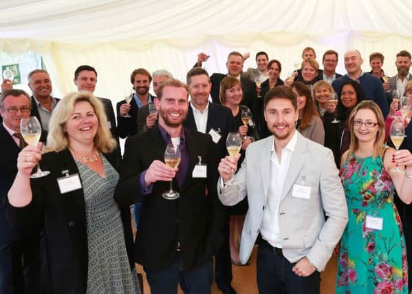 Hybrid Legal's summer drinks party at Hambledon Vineyard with, front from left, Employment Associate Laura Bowyer, Director Matt Schrader, Managing Director Ryan Lisk and Office Manager Charlotte Wills flanked by clients and colleagues.